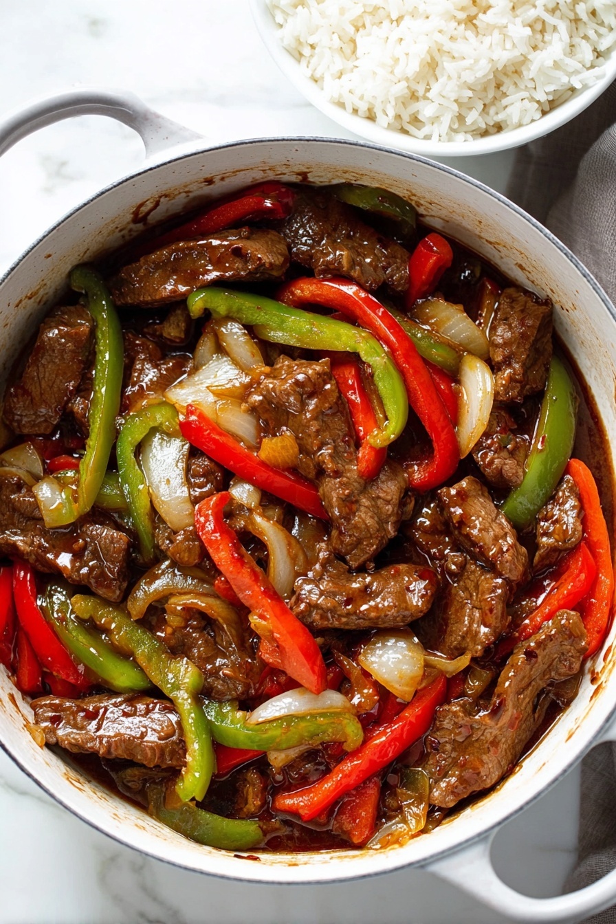 In the image, there is a white pot filled with slices of cooked brown beef mixed with red and green bell pepper strips and onions. The beef pieces are thick and covered with a shiny, brown sauce. The red and green pepper strips add bright colors among the darker beef and sauce, while the onions appear soft and slightly translucent. Next to the pot, there is a bowl filled with white rice on a surface with a white marbled texture. The overall scene looks warm and inviting, with rich, colorful food in focus. photo taken with an iphone --ar 2:3 --v 7