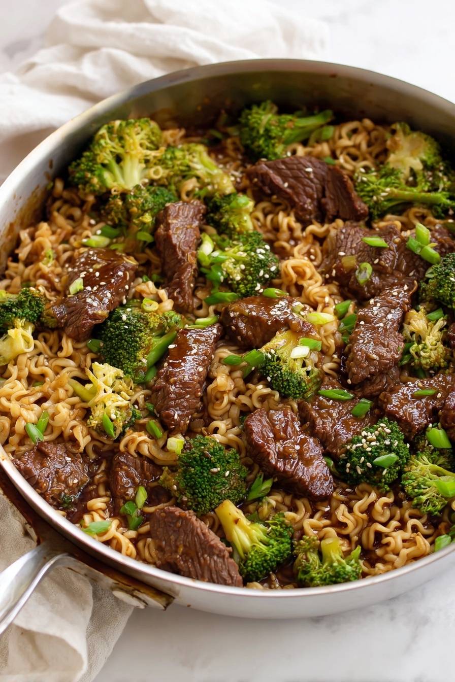 A white metal pan filled with a mix of three main layers: the base layer has soft, curly, light brown noodles, mixed throughout with bright green broccoli florets adding a fresh pop of color, followed by pieces of dark brown, glossy cooked beef scattered evenly on top. The beef pieces have a shiny texture from a rich sauce coating them, with some toasted light sesame seeds sprinkled on and small bits of chopped green onions adding a touch of freshness. The pan rests on a white marbled surface with a soft white cloth in the background. photo taken with an iphone --ar 2:3 --v 7