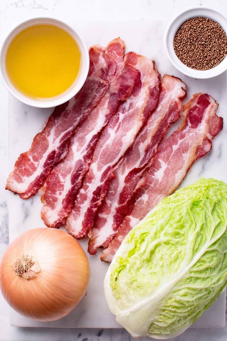Flat lay of thick-cut raw bacon strips arranged loosely, a large fresh green cabbage cut in half showing crisp leaves, a whole large yellow onion peeled with natural skin texture, a small white ceramic bowl filled with clear chicken broth, and a small white ceramic bowl containing whole mustard seeds, all placed on a clean white marble surface, soft natural light, photo taken with an iPhone, professional food photography style, fresh ingredients, white ceramic bowls, no bottles, no duplicates, no utensils, no packaging --ar 2:3 --v 7 --p m7354615311229779997